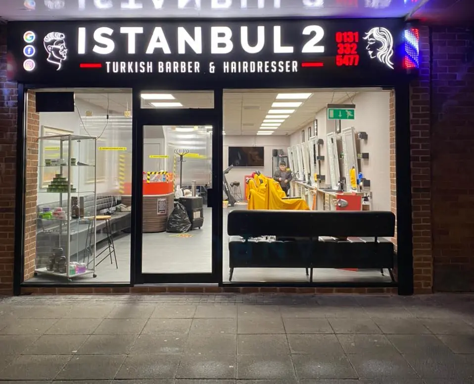 Istanbul 2 Turkish Barber & Hairdresser shopfront lit up at night on Ferry Road